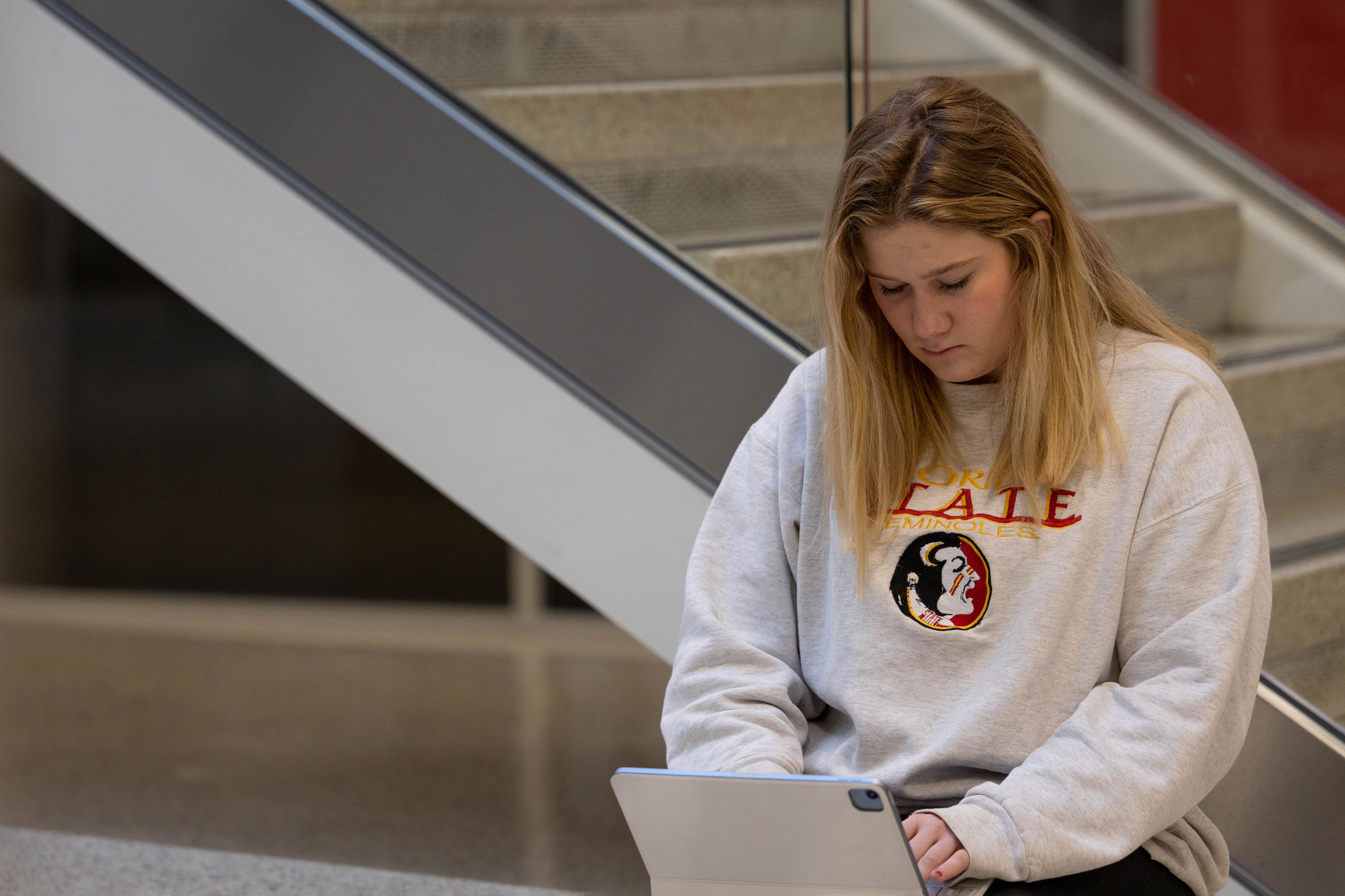 A female student working on her tablet. 