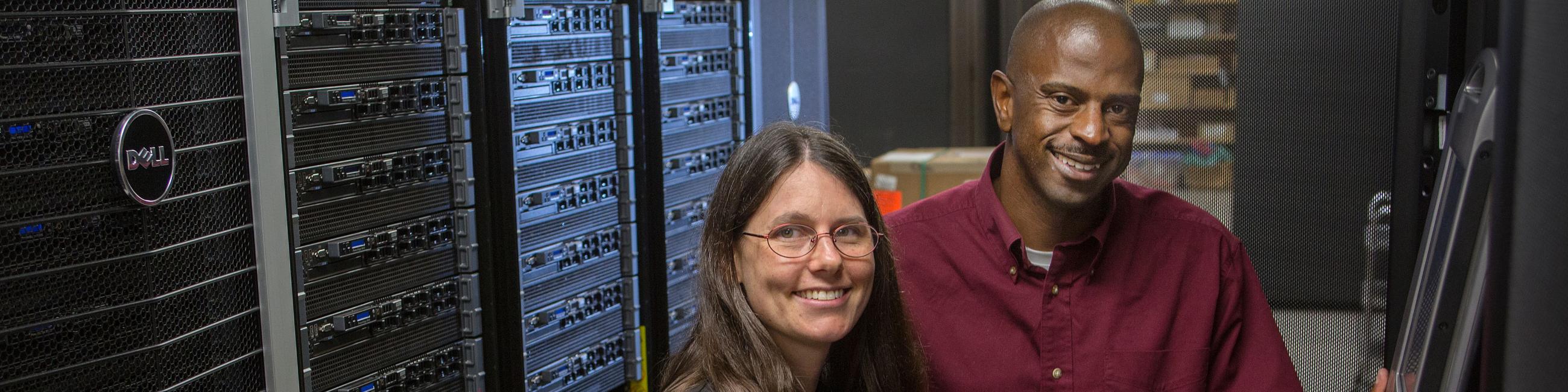 Two IT professional by servers.