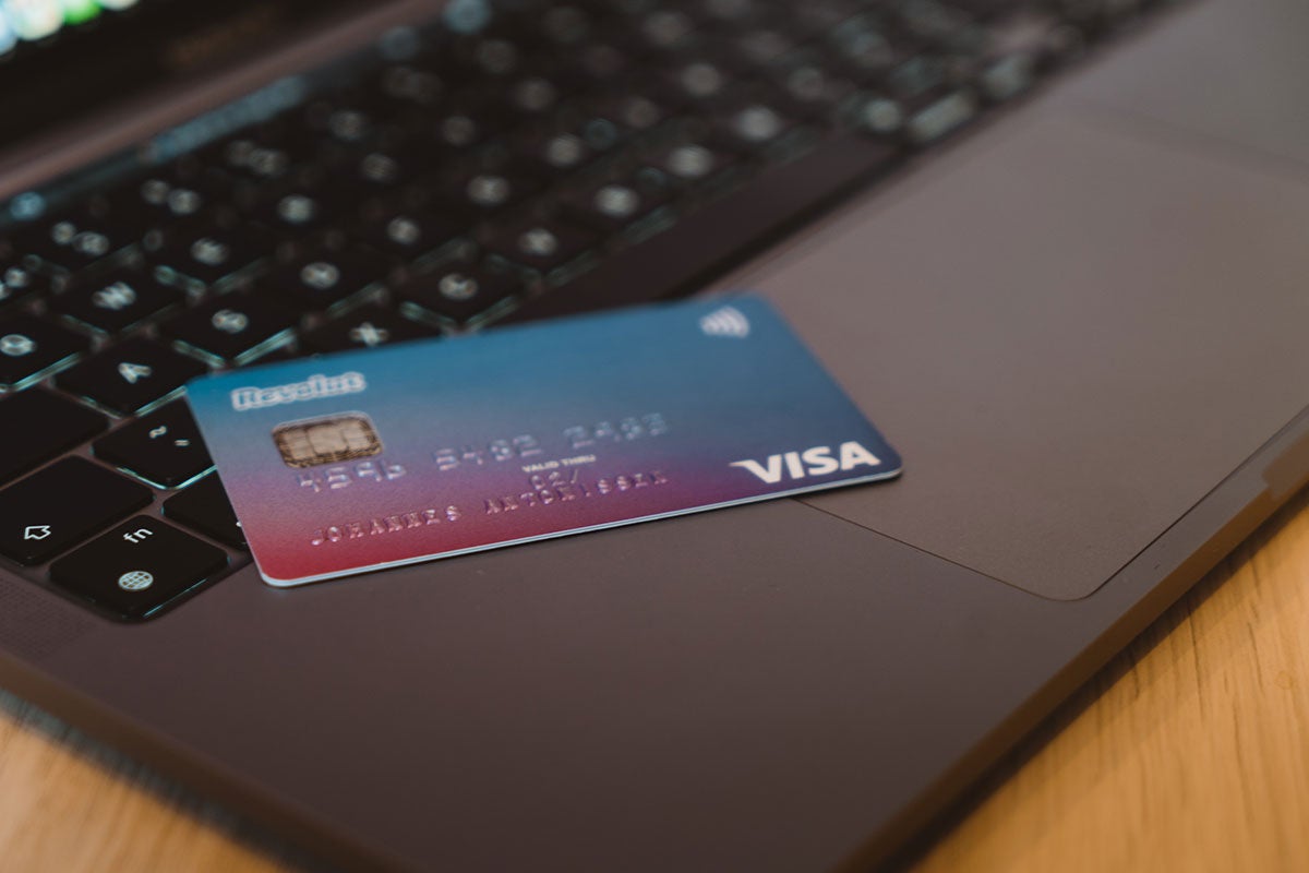 A close up of a credit card sitting on a laptop. 