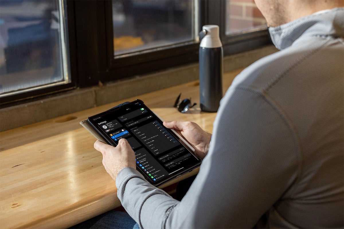 A close up of a man trying to connect his tablet to WiFi. 