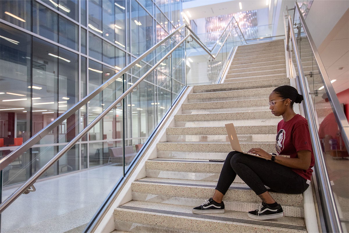 photo of student working on laptop
